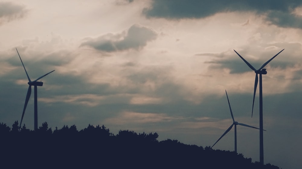 three wind turbines on mountain