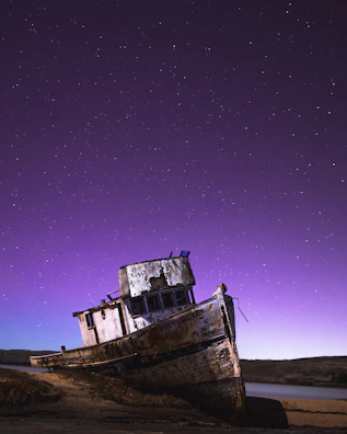 A ghostly shipwreck resting beneath shadowy waves, bathed in moonlight.