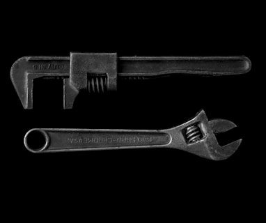 gray adjustable wrench and gray pipe wrench
