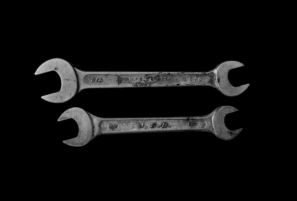 two silver open wrenches