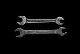 Two silver wrenches are positioned horizontally against a black background. The upper wrench has the inscription 'INDESTRO CHICAGO U.S.A.' with measurements indicated as '1/2'. The lower wrench is labeled 'MADE IN JAPAN' with measurements marked as '12' and '10'.