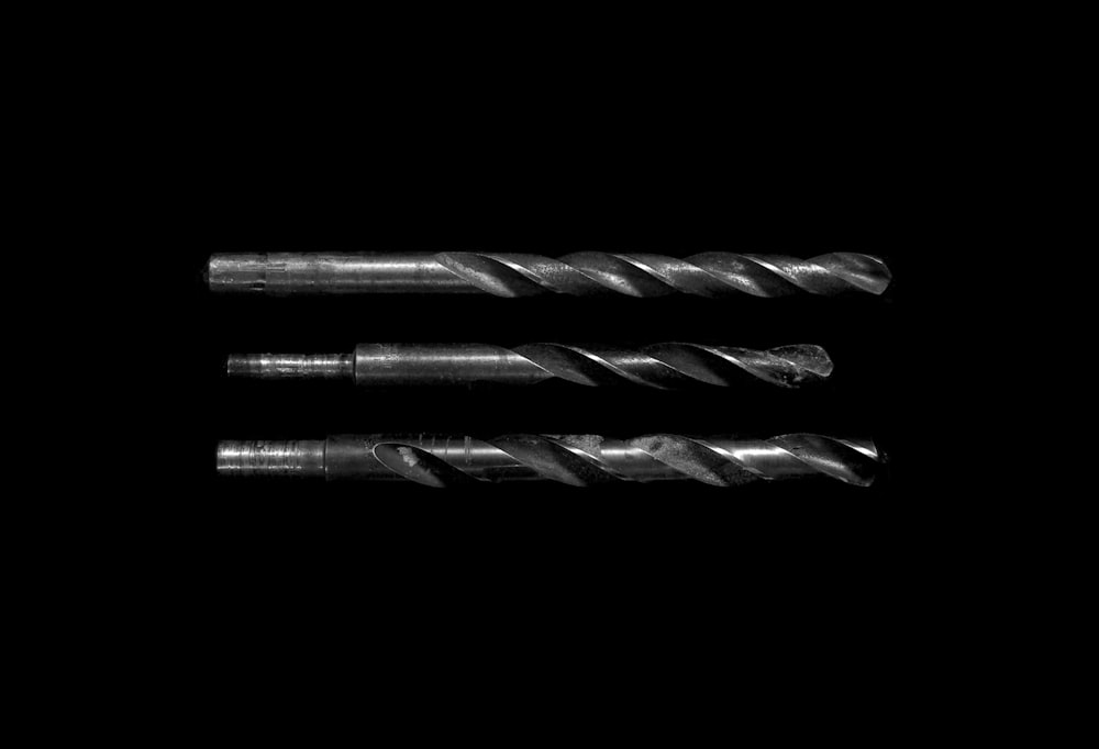 grayscale photo of drill bits