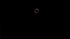 A crowd gathered in awe under the darkened sky during a total solar eclipse in Spain.