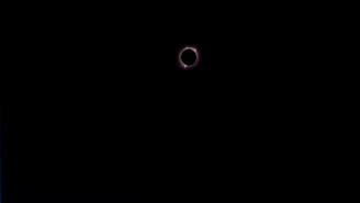 A crowd gathered in awe under the darkened sky during a total solar eclipse in Spain.