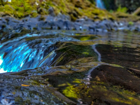 An outdoor scene of a water source with clear blue water, representing purity.