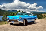 A classic car parked in a scenic landscape.
