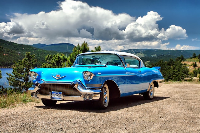 A classic car parked in a scenic landscape.