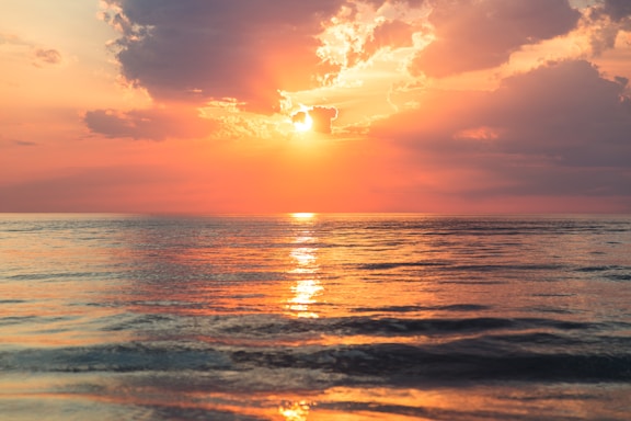 Lake Michigan under white clouds at golden hour