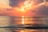 sea under white clouds at golden hour