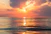 sea under white clouds at golden hour