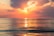 sea under white clouds at golden hour