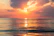 sea under white clouds at golden hour