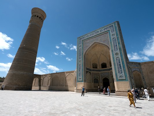 Blue and brown building with blue and brown archway under blue sky — Bukhara, Uzbekistan