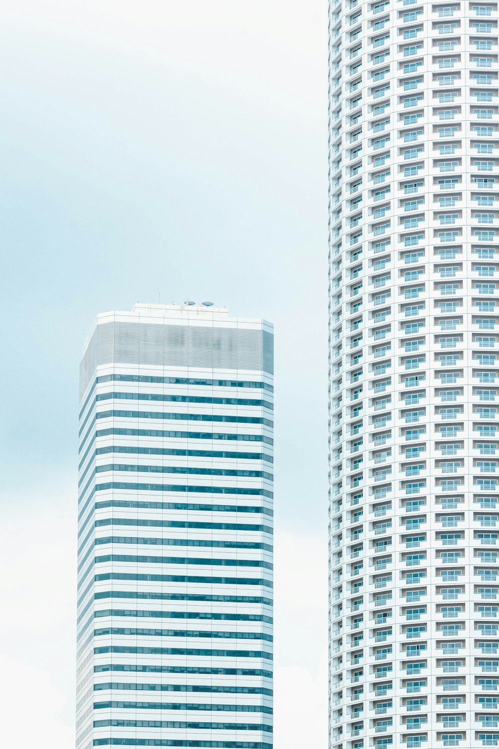 white skyscraper under white and blue skies