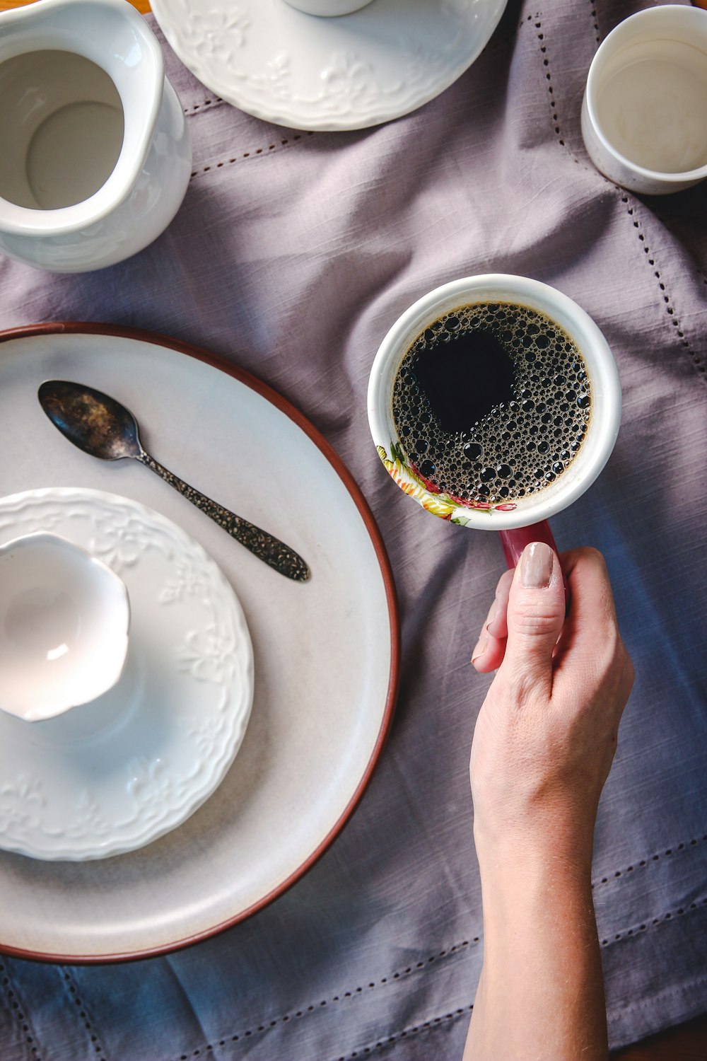 Taza de cerámica roja y blanca con café