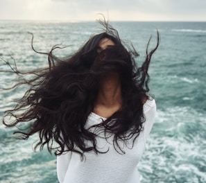 woman standing near body of water during daytime