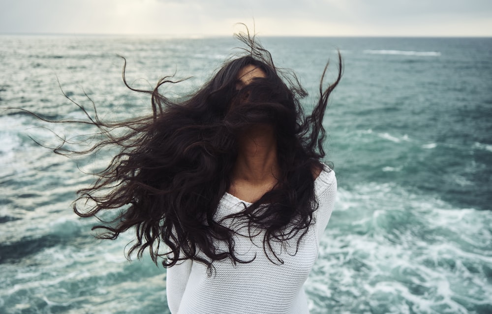 woman standing near body of water during daytime