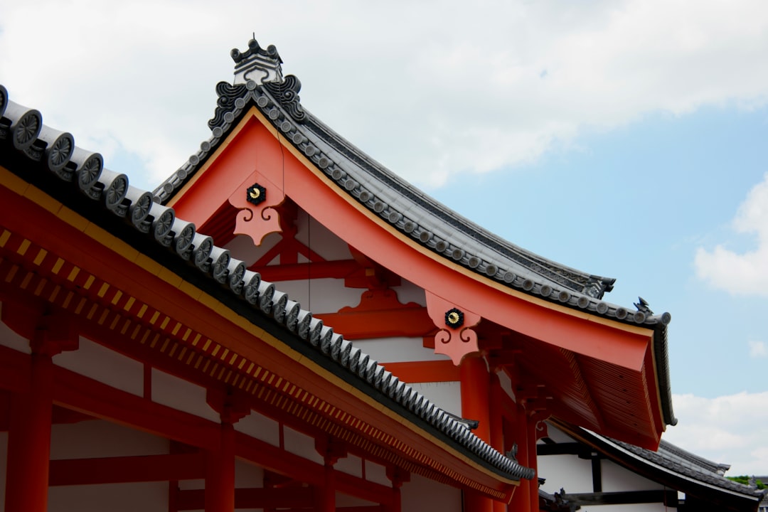orange and gray castle under white and blue sky at daytime, Temple rooftop