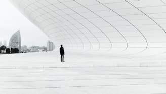 person standing in a middle of white plate field
