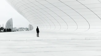 person standing in a middle of white plate field