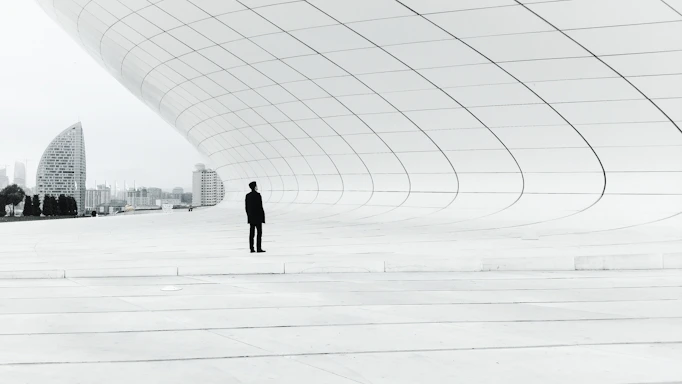 person standing in a middle of white plate field