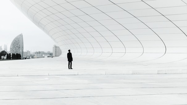 person standing in a middle of white plate field