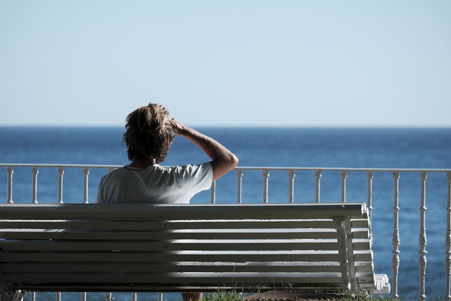 A solo traveller sitting on a bench by the water, taking quiet time alone