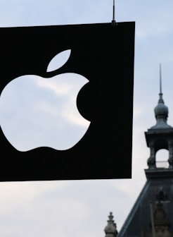 Apple logo in front of a building