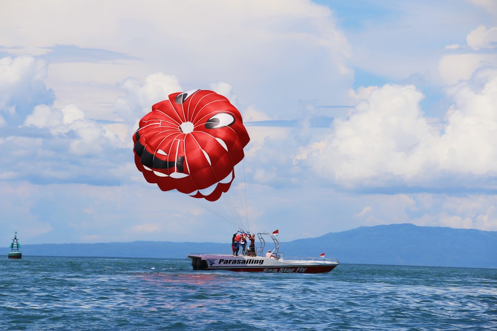 black and white motor boat catching skydiver