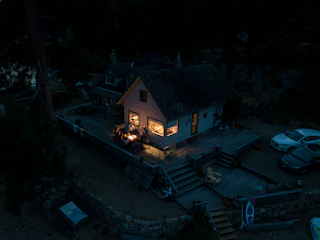 Group gathered around a rustic wooden table inside a cozy forest cabin.