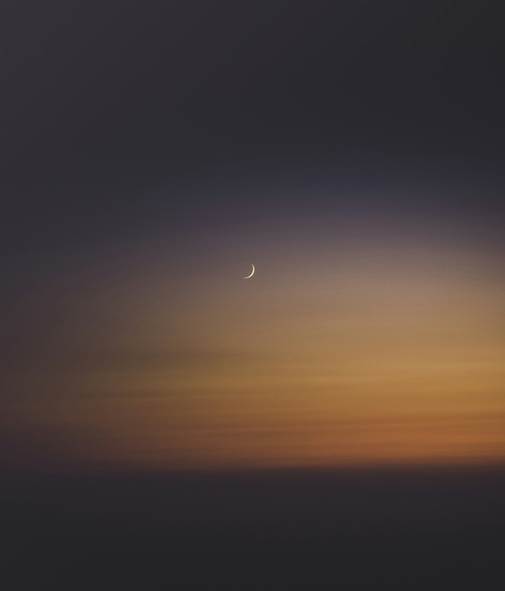 crescent moon during sunset