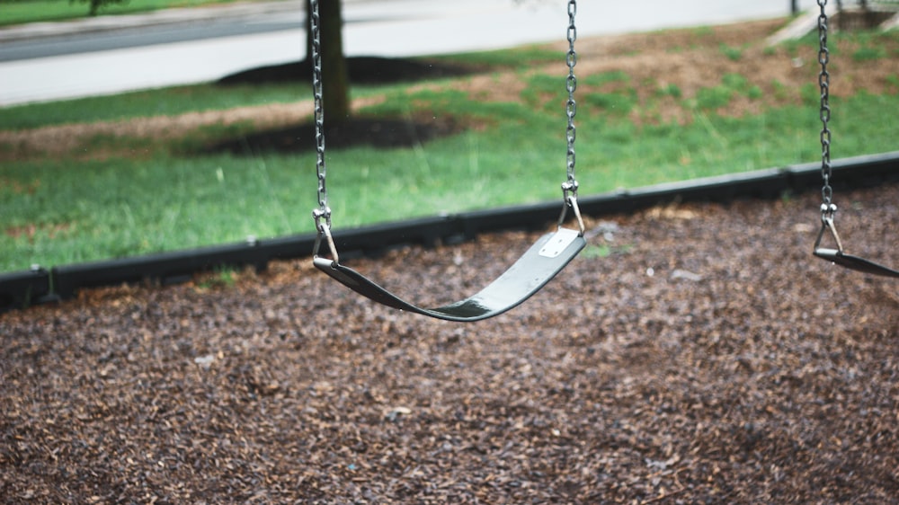 shallow focus photo of playground swing