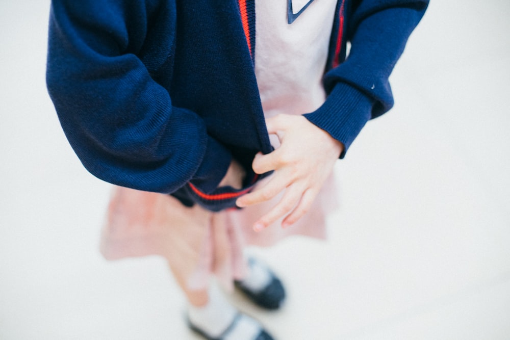 woman tugging her blue jacket