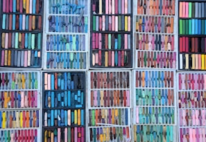 A vibrant collage of pastel-colored craft supplies arranged neatly on a light blue background