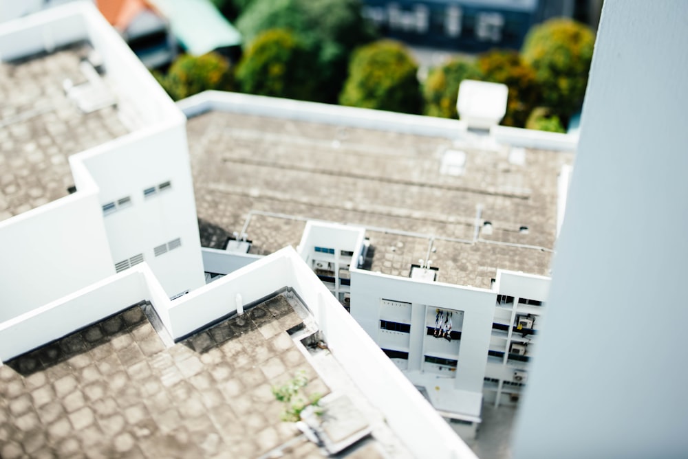 tilt-shift photography of white concrete buildings during daytime