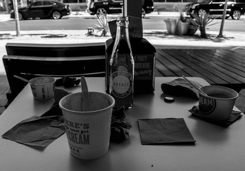 Photo of various disposable packaging products for horeca businesses on a wooden table.