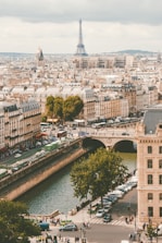 group of people walking near body of water and building under blue sky at daytime