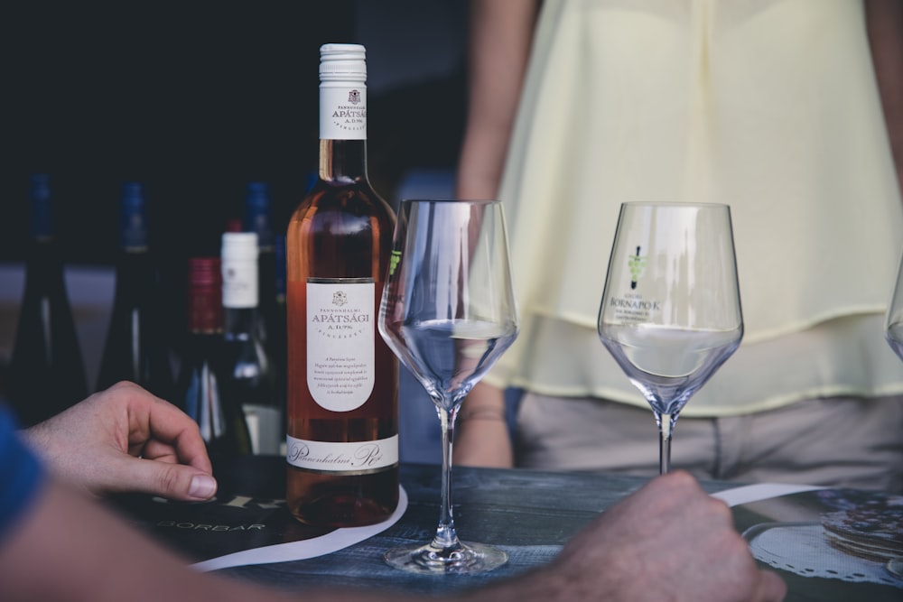 person holding clear wine glass