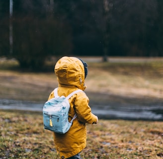 shallow focus photo of toddler walking near river