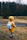 shallow focus photo of toddler walking near river