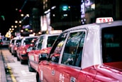 Star Cabs fleet lined up neatly, shining under city lights ready for corporate events.
