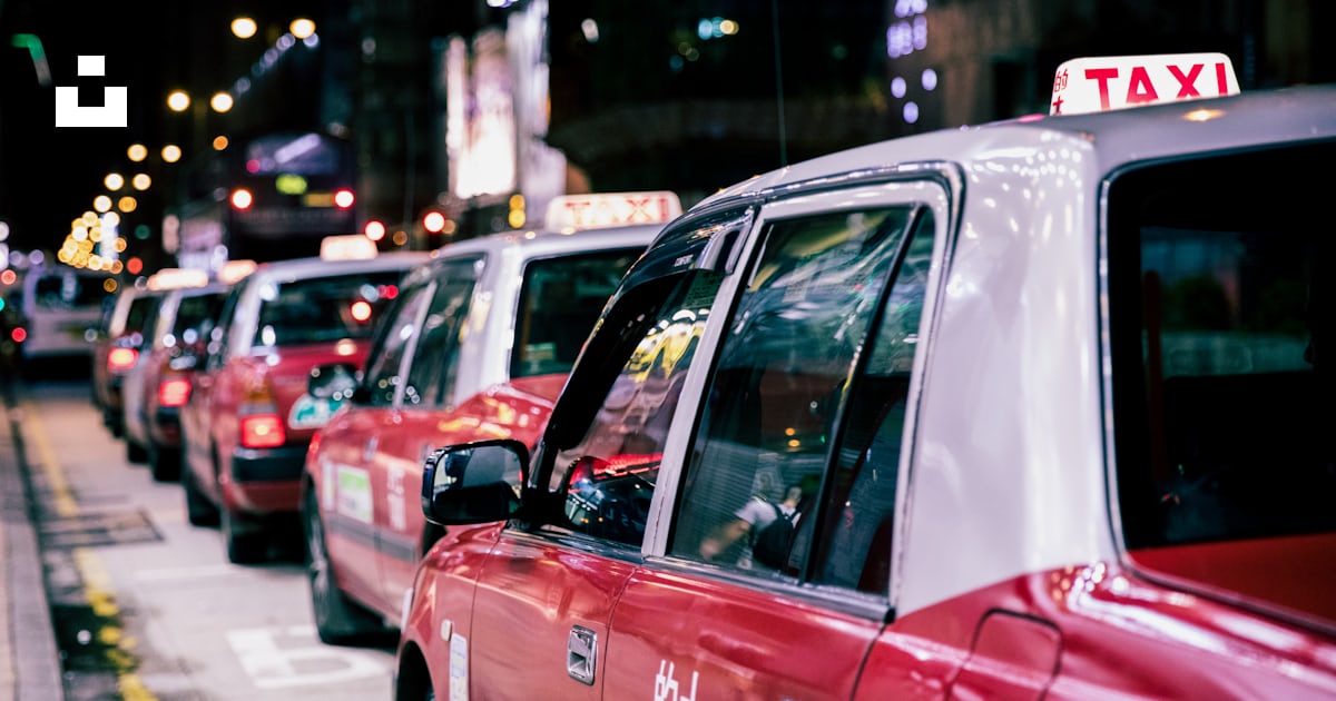 Red taxis on road during nighttime photo – Free Cab Image on Unsplash