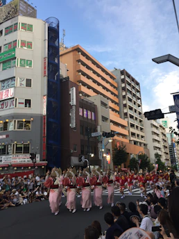 Street artists performing with colorful decorations and engaged audience enjoying the moment.