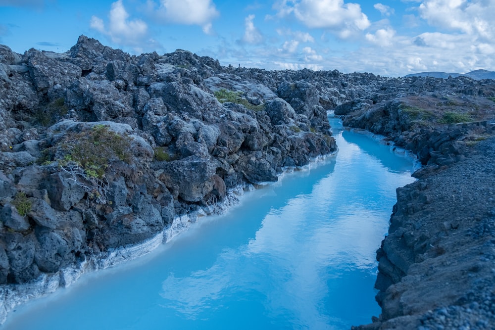 landscape photo of rock formation near body of river