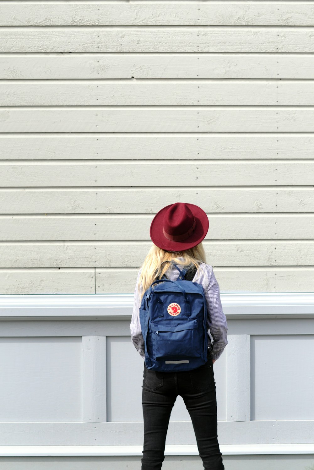 woman standing in front of wooden wall