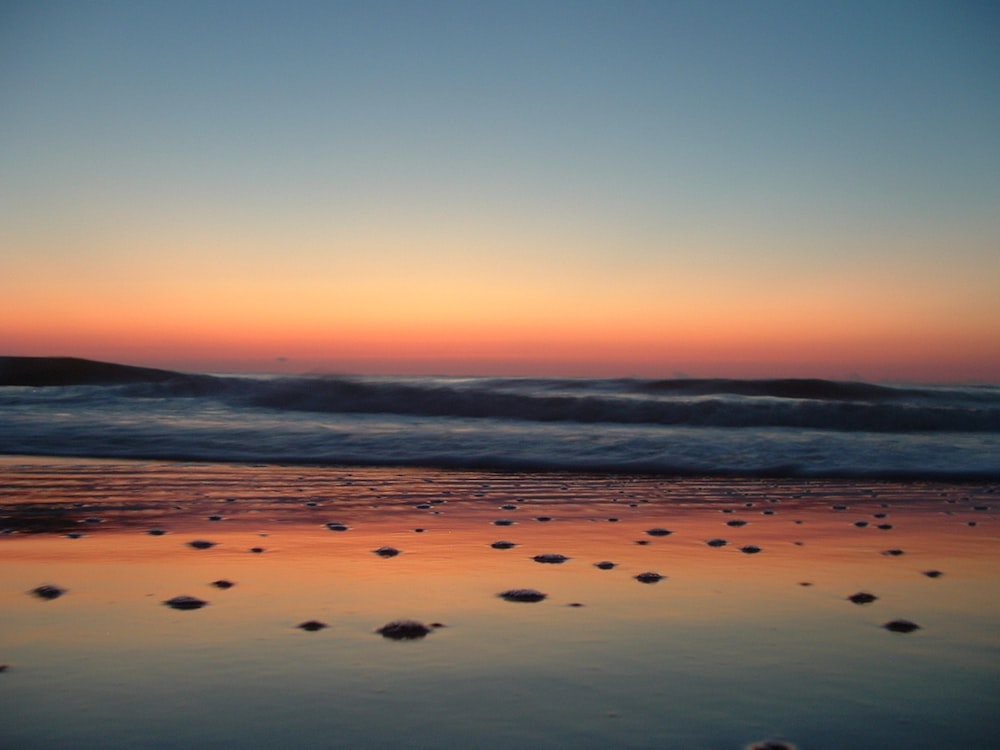 water waves on seashore during daytime