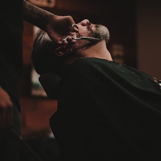 man sitting on barber's chair