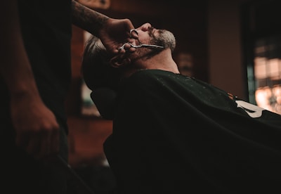 man sitting on barber's chair