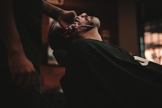 man sitting on barber's chair