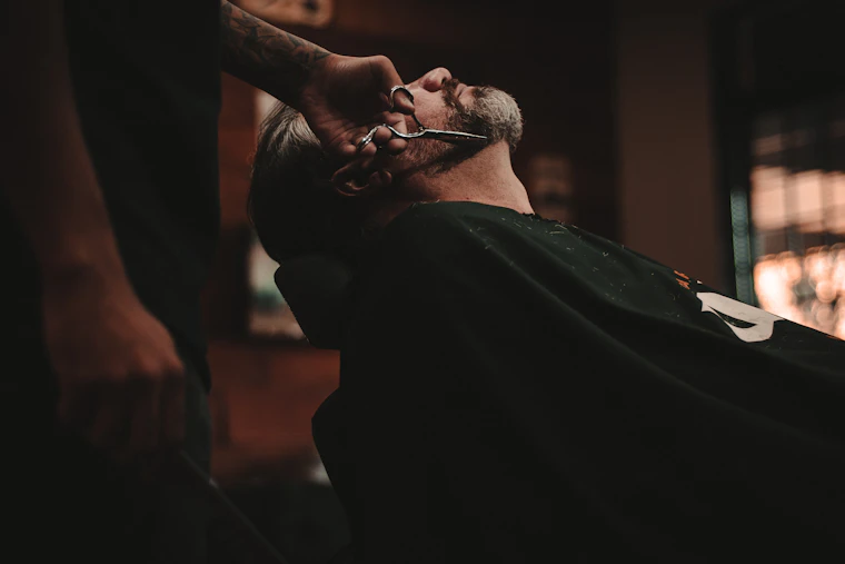 A barber finishing a haircut